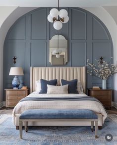 a large bed sitting under a mirror in a bedroom