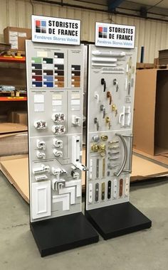 two display boards with different types of hardware on them in a warehouse or storage area