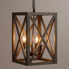 a wooden light fixture with three candles in it