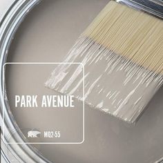 a paint can with the words park avenue painted on it next to a white brush