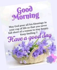 a basket filled with purple flowers sitting on top of a white table next to a sign that says good morning