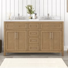 a bathroom vanity with two sinks and a rug on the floor in front of it