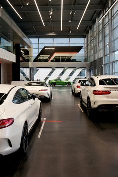 there are many different cars parked in the garages and one is white with black trim