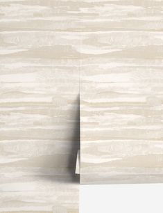 a white marble wall with an empty piece of paper hanging from it's side