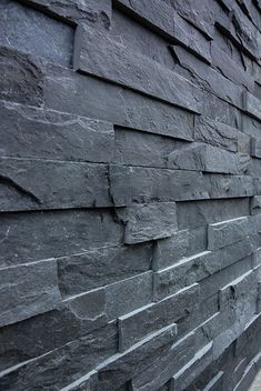 a black stone wall with the word megadome on it's side in white lettering