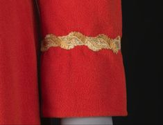 a red coat with gold trim on it