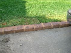 a fire hydrant sitting on the side of a road next to a grass field