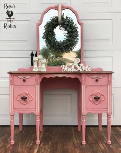 pink vanity with mirror and wreath on top