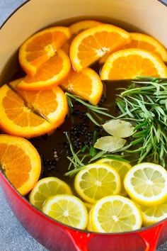 a pot filled with lemons and herbs