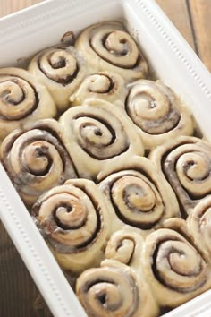 cinnamon rolls in a white baking dish with text overlay that reads, better than cinnamon cinnamon rolls with buttercream glaze