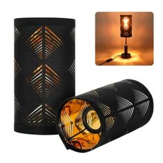 a lamp that is sitting on top of a black cylinder with an orange light in the middle