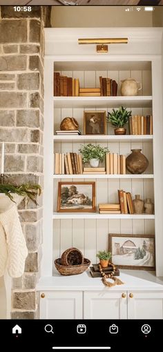 a book shelf with books and pictures on it