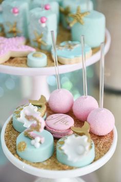 two tiered trays holding different types of cakes and pastries on top of each other