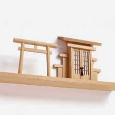 a wooden shelf with a doll house on it