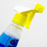 a blue bottle with yellow cap and handle