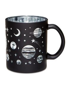 a black coffee mug with planets and stars on it