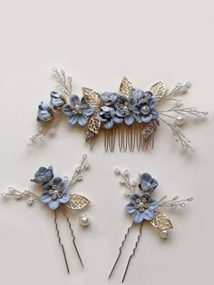 three hair combs with blue flowers and leaves on top of each other, sitting next to each other