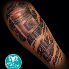 a man's arm with a tattoo on it that has an engine in the middle