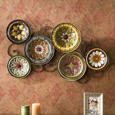 there are many plates on the wall with flowers