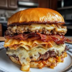 a cheeseburger with meat, bacon and melted cheese on a plate in a kitchen