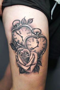 a woman's thigh with a rose and two clocks on it, all in the shape of a heart