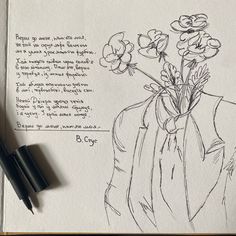 a drawing of flowers in a vase with writing on the paper next to two pens