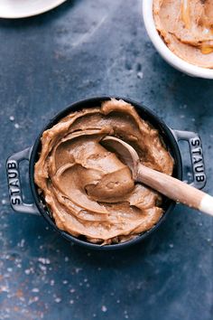 a bowl filled with peanut butter next to other bowls