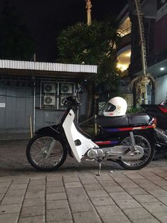 a motorcycle parked on the side of a road next to a motor scooter