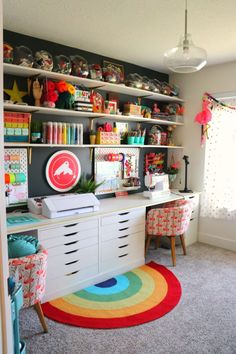 a room filled with lots of colorful furniture and decor on top of bookshelves