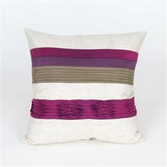 a white pillow with purple and brown stripes