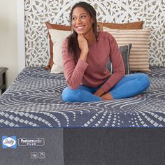 a woman sitting on top of a blue mattress