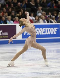 a female figure skating on an ice rink