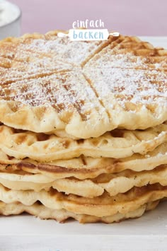 a stack of pancakes with powdered sugar on top