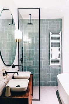 a bathroom with two sinks and a large mirror in the middle of it's wall