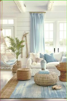 a living room filled with lots of furniture and decor on top of a blue rug