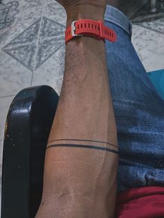 a man with a red wristband sitting on a chair