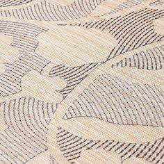 a close up view of an area rug with lines and shapes on the ground,