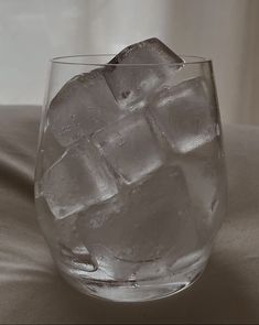 a glass filled with ice on top of a table