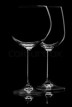 two empty wine glasses sitting next to each other