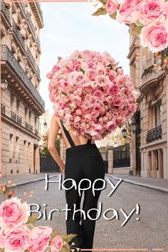 a woman holding a large bouquet of flowers in front of her face with the words happy birthday