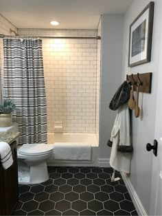 the bathroom is clean and ready to be used as a shower curtain or towel rack