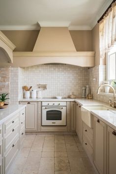 Bright, all-white kitchen with subway tile backsplash, stainless steel appliances, and elegant white cabinetry. #TheKitchen #AKitchen #WhiteKitchenCabinets #KitchenCabinetColorIdeas White Elegance