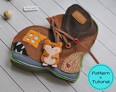 a pair of brown boots sitting on top of a wooden floor next to other items