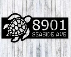 a sign that says 991 seaside ave with a sea turtle on the front and side