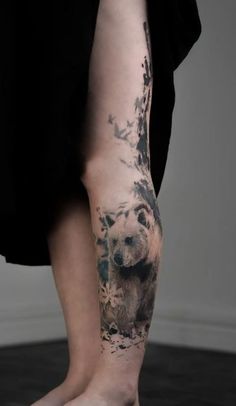 a person with a bear tattoo on their leg