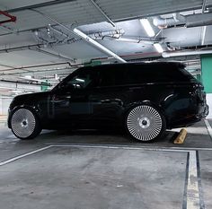 a black car parked in a parking garage