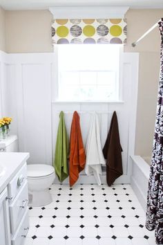 a bathroom with towels hanging on the wall