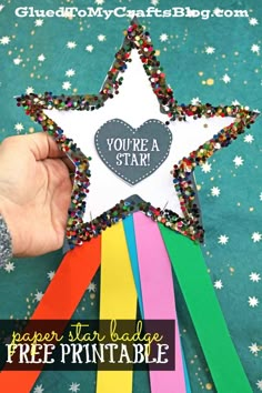 someone is holding up a paper star with the words free printable on it