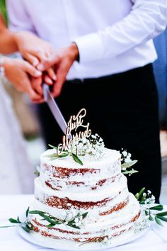 a bride and groom cutting their wedding cake