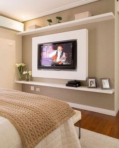 a bedroom with a large flat screen tv mounted to the wall